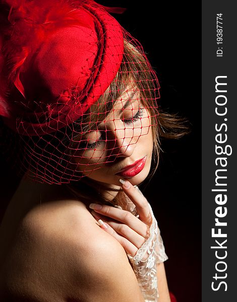 Woman in red hat with net veil