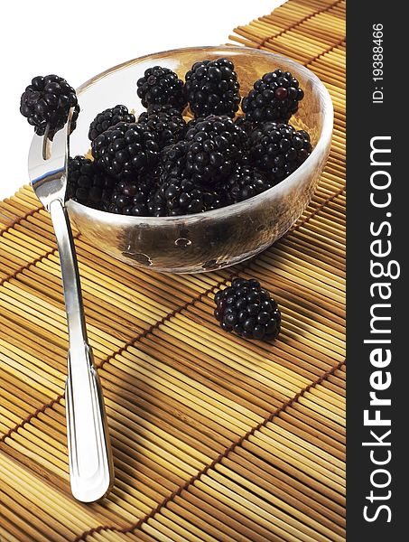 Blackberry in dish with the fork isolated on white. Blackberry in dish with the fork isolated on white