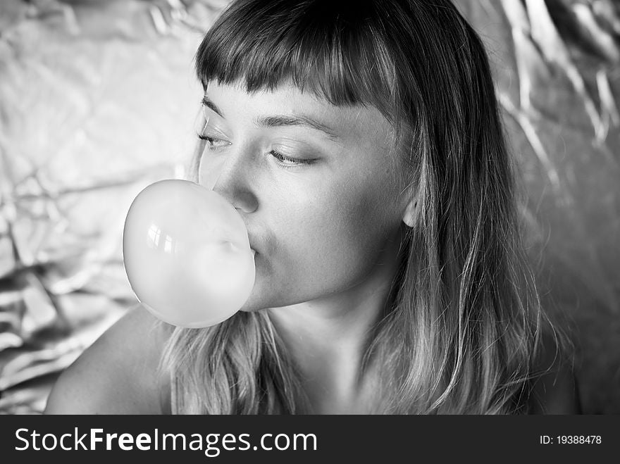 Girl making a bubble from chewing gum