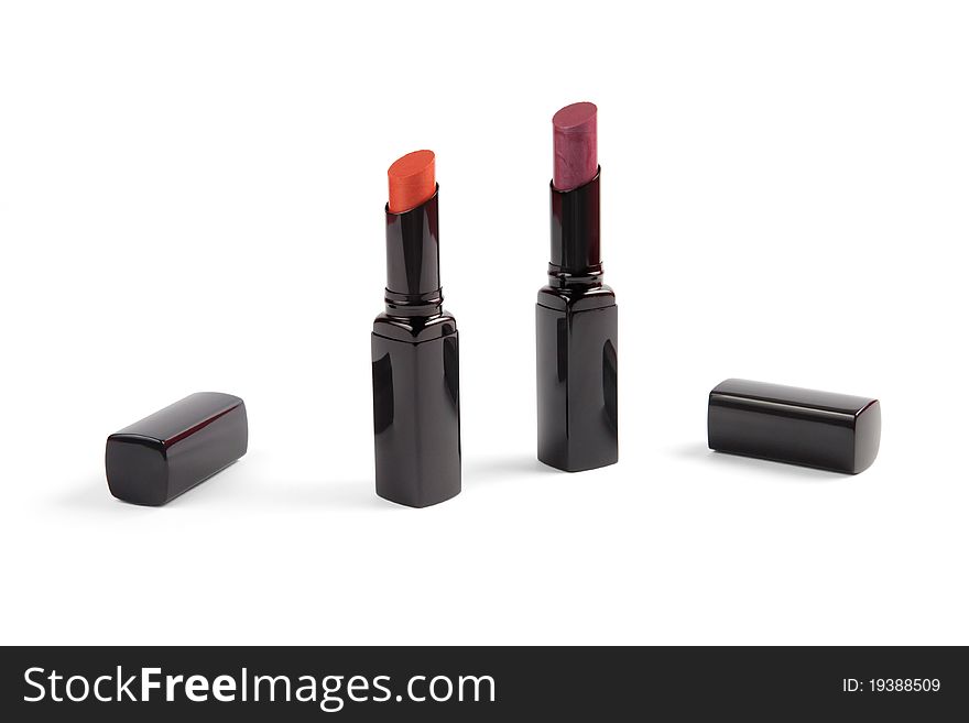The two open lipsticks: orange and purple.