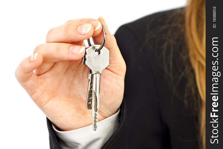 Two silver keys in woman hands in suit