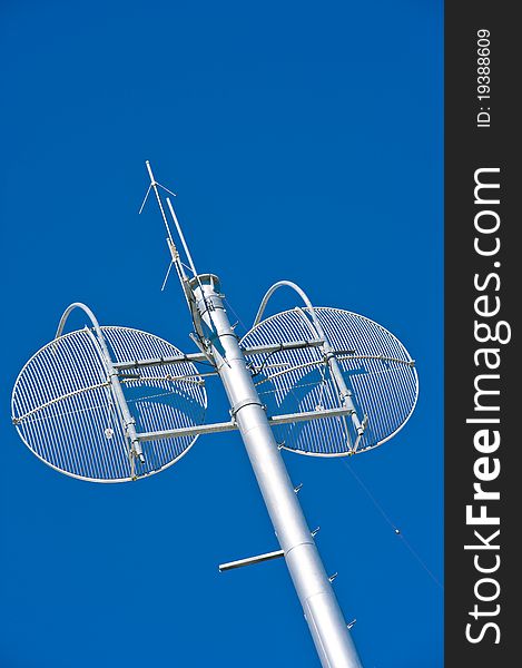 A new communications tower with twin transparent steel sattelite dishes, and communications antennae