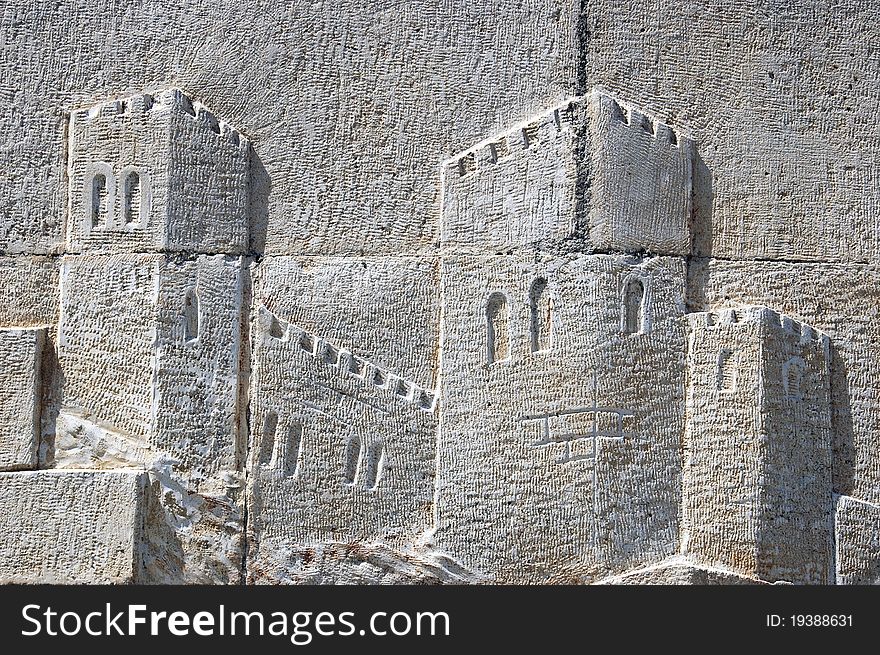 Detail of stone wall of a castle in relief. Detail of stone wall of a castle in relief