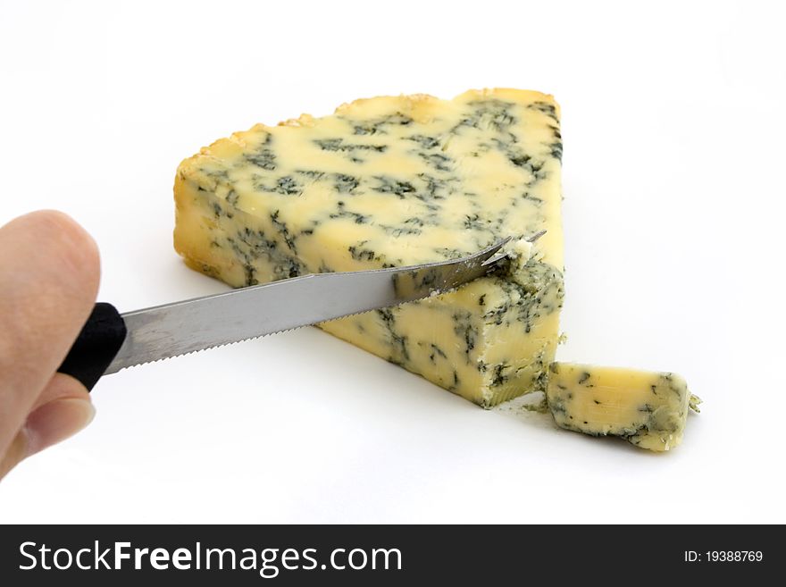 Blue cheese being cut isolated on white. Blue cheese being cut isolated on white