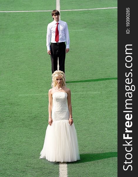 Bride and groom on football stadium