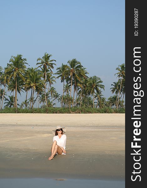 Woman in white hat lying on the beach in tropical country. Woman in white hat lying on the beach in tropical country