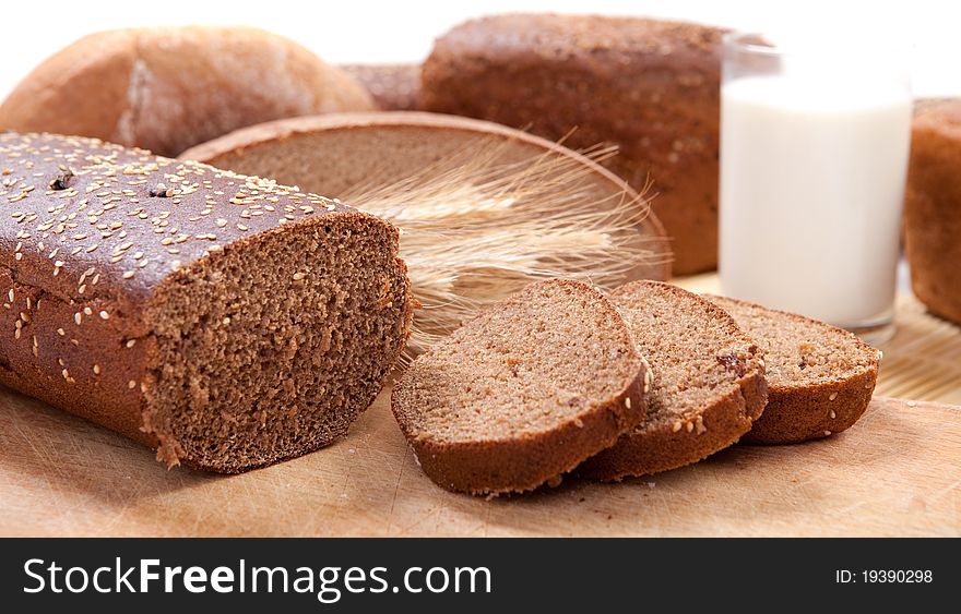 Fresh brown bread with a glass of milk