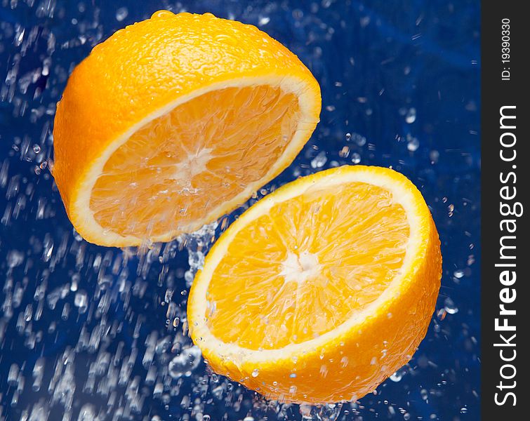 Fresh sweet orange under drops of water