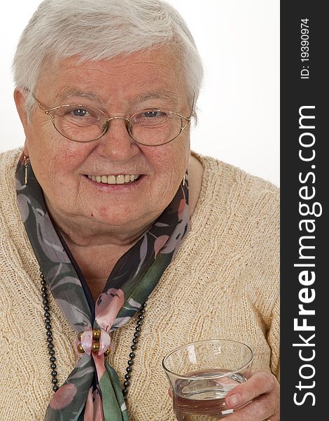 Senior woman drinking water on bright background