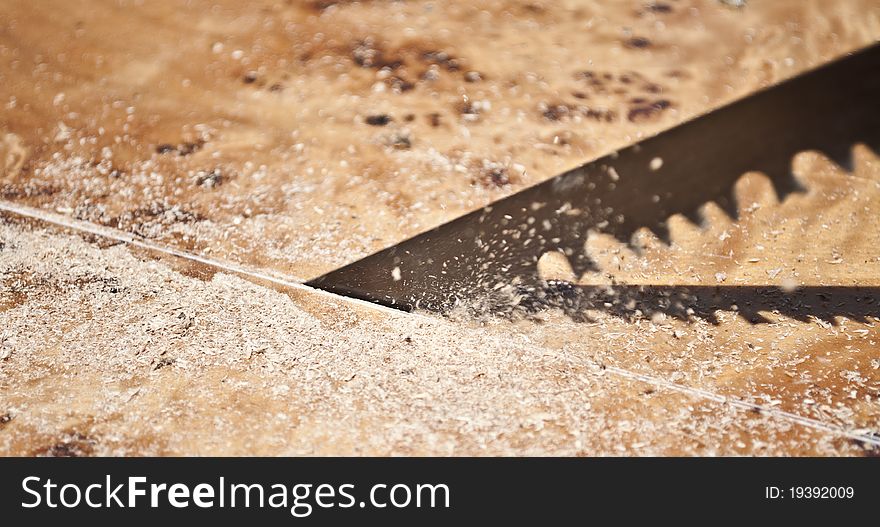 Close-up of a saw cutting wood furniture