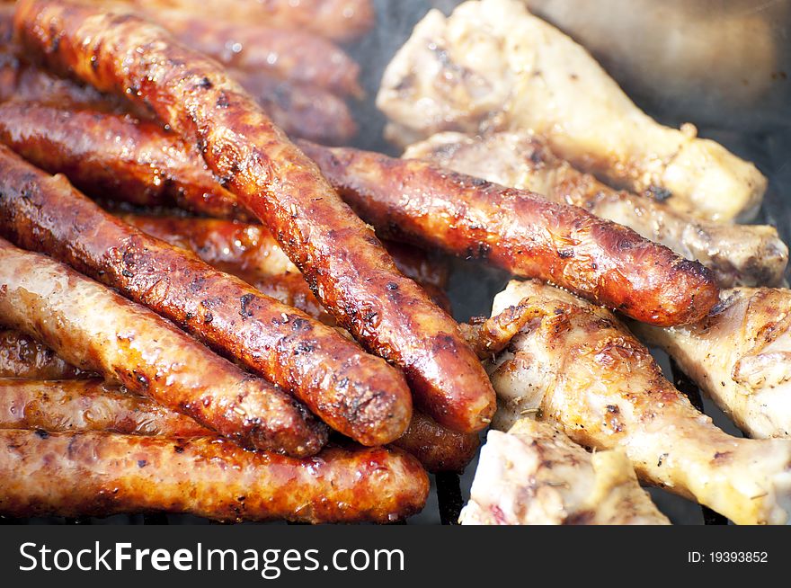 Sausages and white meat - barbecue background