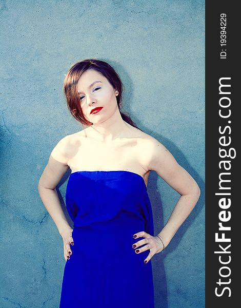 Portrait of a beautiful woman in blue dress