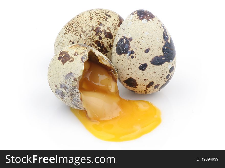 Isolated broken  partridge eggs in white background