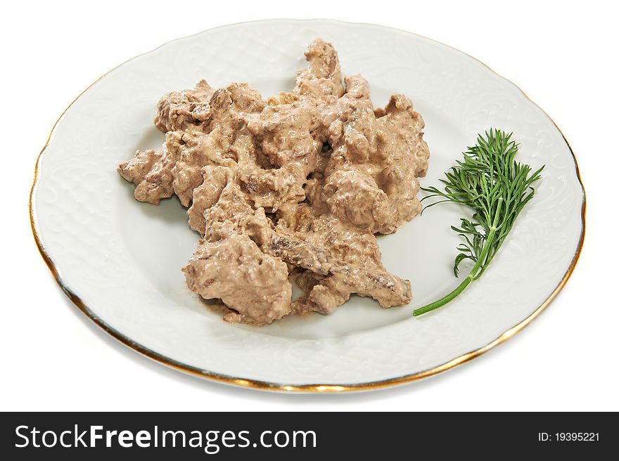 Beef liver baked in sauce with fennel on plate isolated on white background