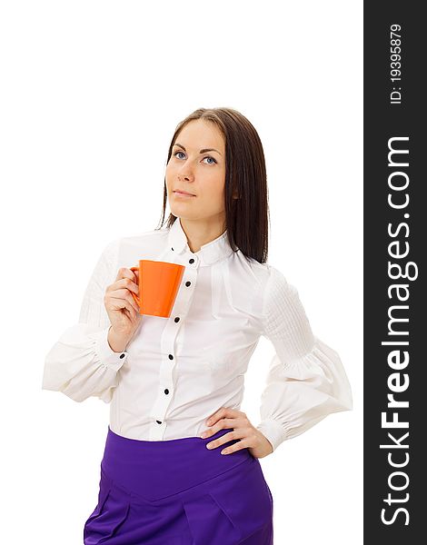 Dreamy beautiful girl in white blouse and violet skirt standing and holding orange cup. Dreamy beautiful girl in white blouse and violet skirt standing and holding orange cup.