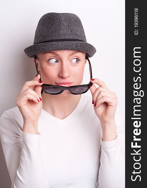 Retro photo of a girl in sunglasses and an old hat