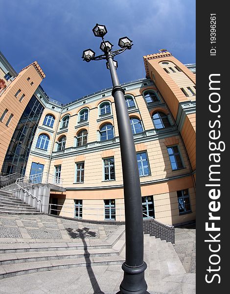 Facade of the building in pastel colors and a stylish lantern