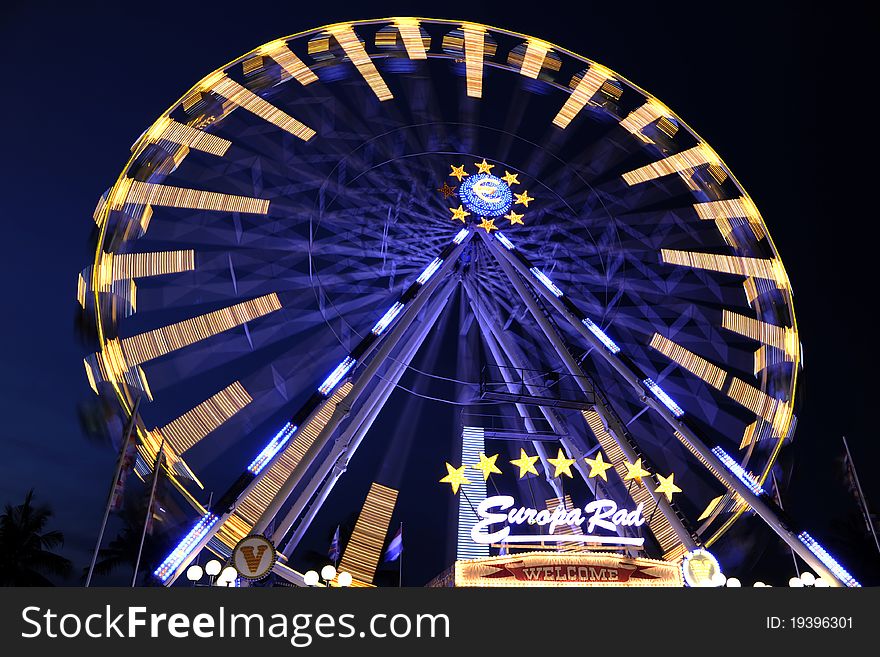 A Ferris wheel (also known as an observation wheel or big wheel) is a nonbuilding structure consisting of a rotating upright wheel with passenger cars (sometimes referred to as gondolas or capsules) attached to the rim in such a way that as the wheel turns, the cars are kept upright, usually by gravity.