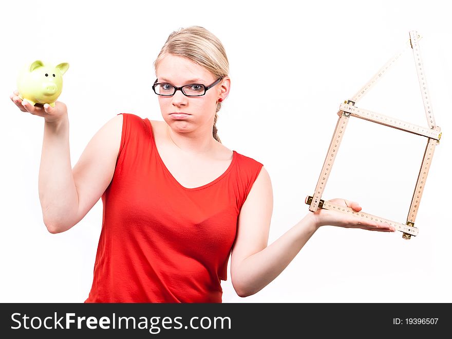 Young woman with house symbol and piggy bank