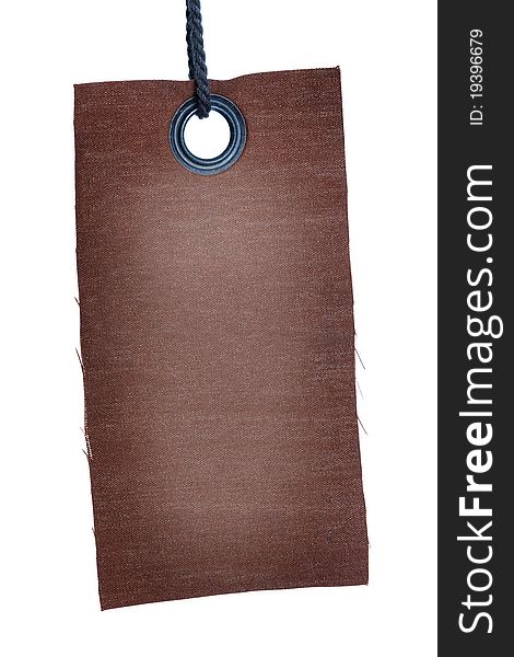 Brown fabric tag with metal brail and grey thread attached isolated on white background. Brown fabric tag with metal brail and grey thread attached isolated on white background.