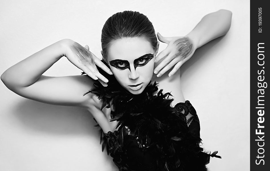 Portrait of a young woman with makeup black swan