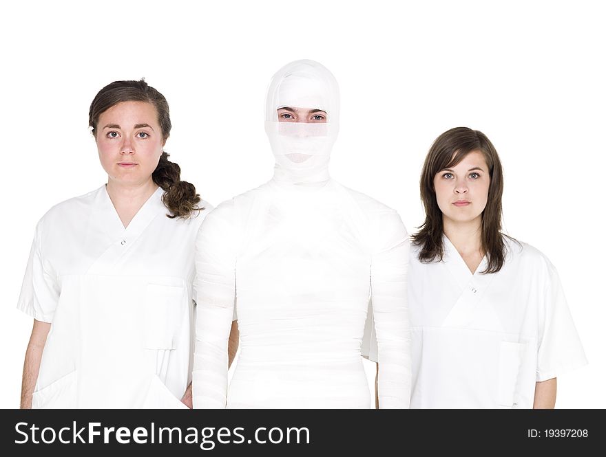 Mummified person with two female nurses. Mummified person with two female nurses
