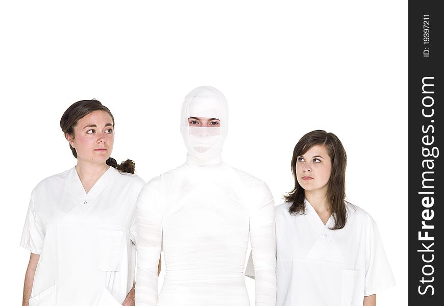 Mummified person with two female nurses. Mummified person with two female nurses