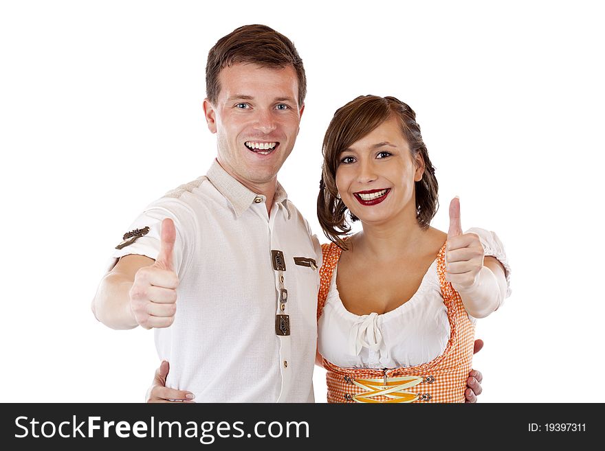 Successful man and woman with dirndl hold thumbs up. Isolated on white background. Successful man and woman with dirndl hold thumbs up. Isolated on white background.