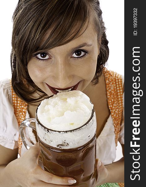 Young beautiful woman with dirndl drinks Oktoberfest beer stein.Isolated on white background.