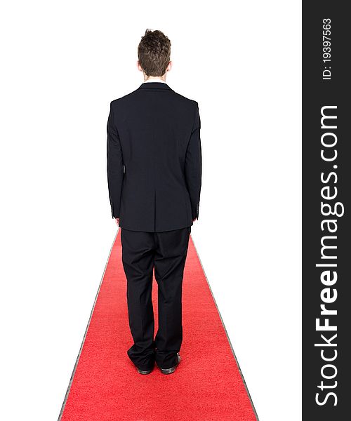 Man from behind on a red carpet isolated on white background