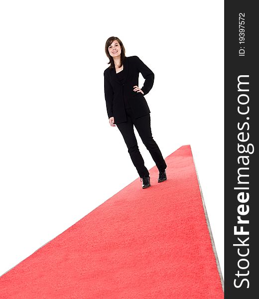 Smiling girl walking on red carpet isolated on white