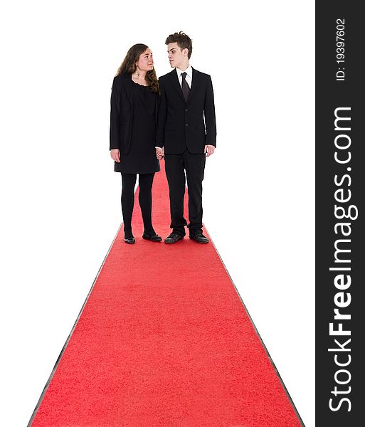 Couple standing on a red carpet isolated on white background