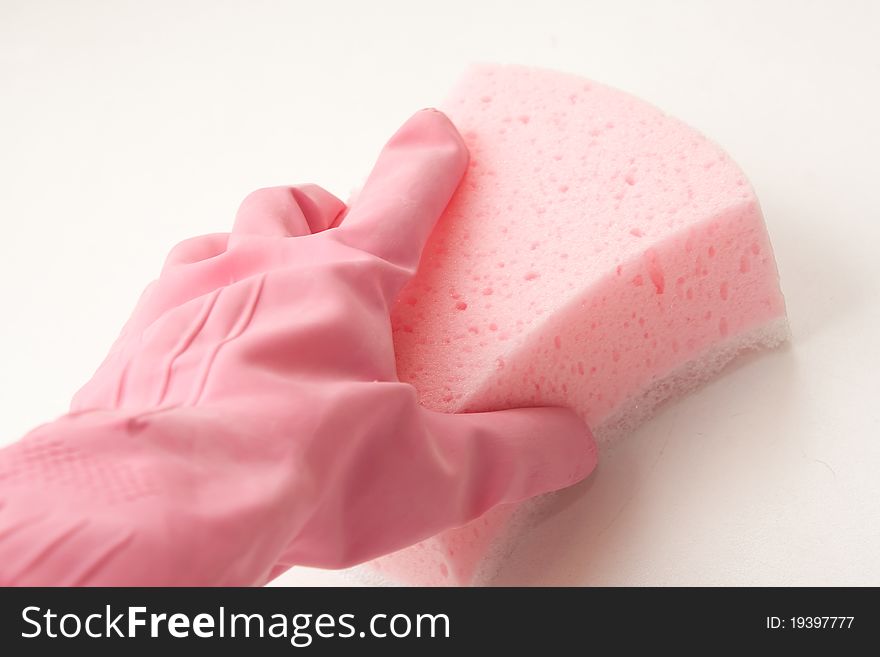 Hand in a pink rubber glove holding a pink sponge. Hand in a pink rubber glove holding a pink sponge
