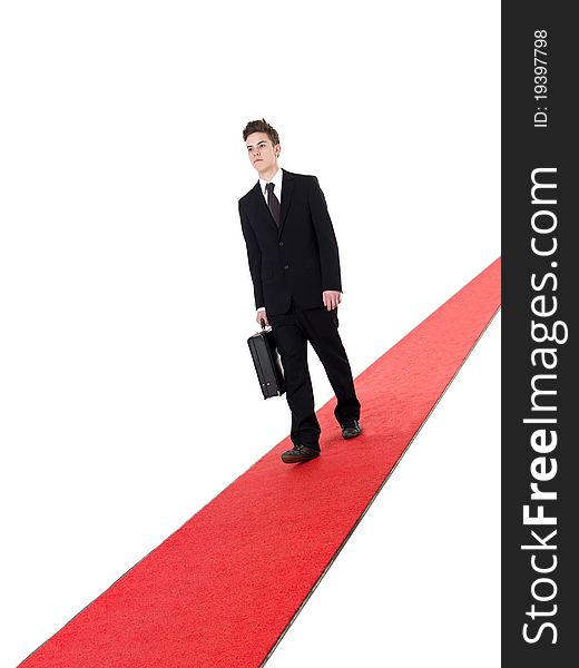 Businessman on a red carpet isolated on white background