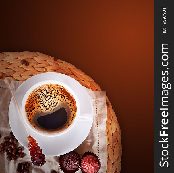 Coffee cup with sugar stick and beans on dark background. Coffee cup with sugar stick and beans on dark background