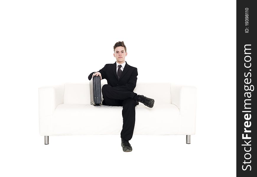 Businessman sitting in a sofa isolated on white background