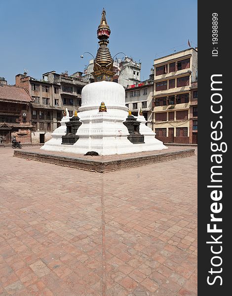 A chÃ¶rten (stupa, small temple) in the courtyard, Kathmandu, Nepal. A stupa is a mound-like structure containing Buddhist relics used by Buddhists as a place of worship.