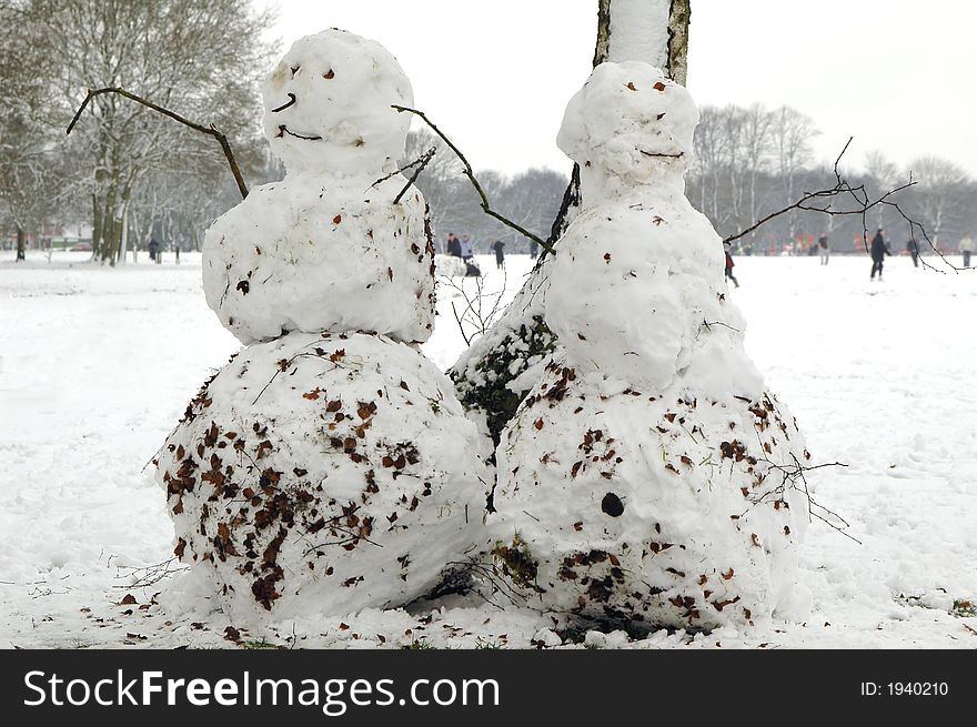 Snowmen in wintery park setting
