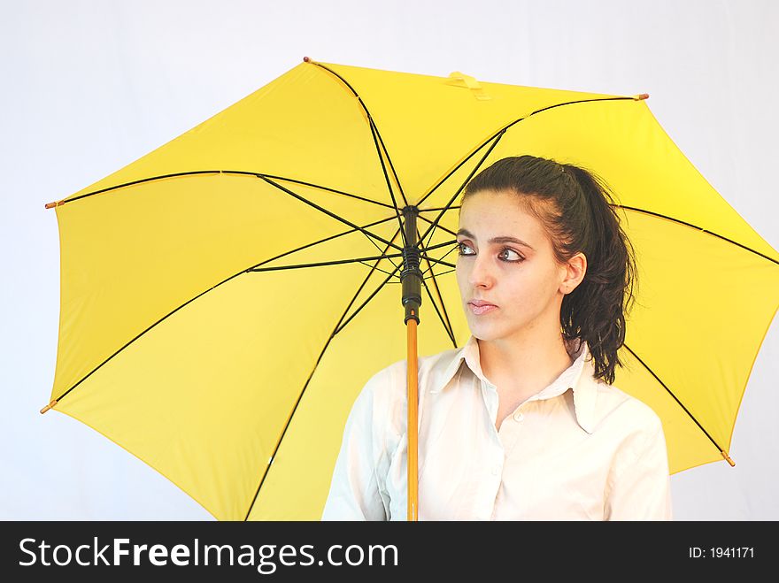 Women with yellow umbrella posing. Women with yellow umbrella posing