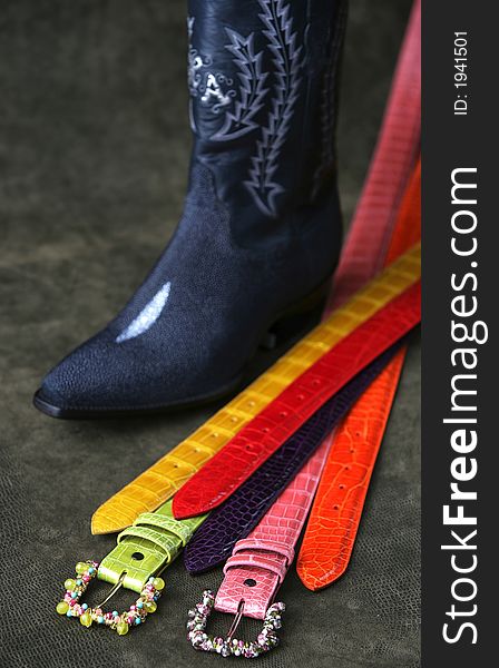 Western colorful belts and a cowboy boot. Western colorful belts and a cowboy boot