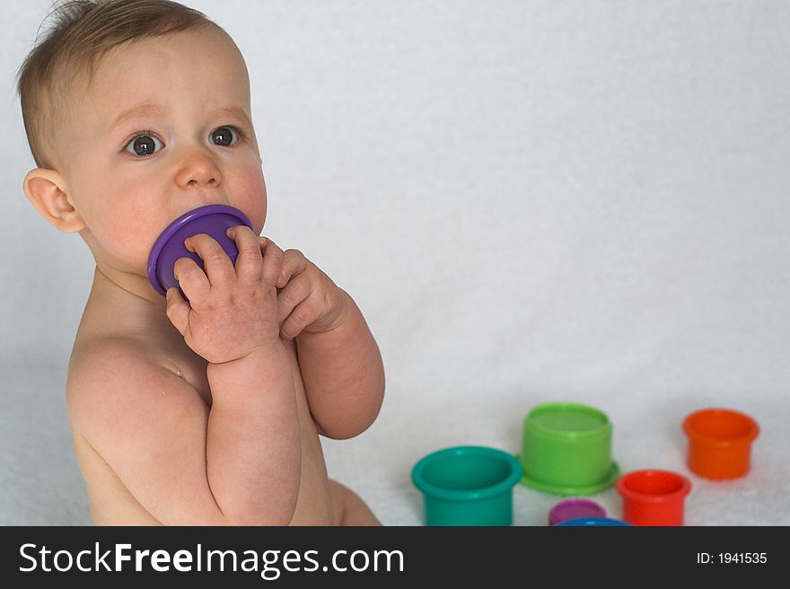 Image of adorable baby playing with stacking cups. Image of adorable baby playing with stacking cups