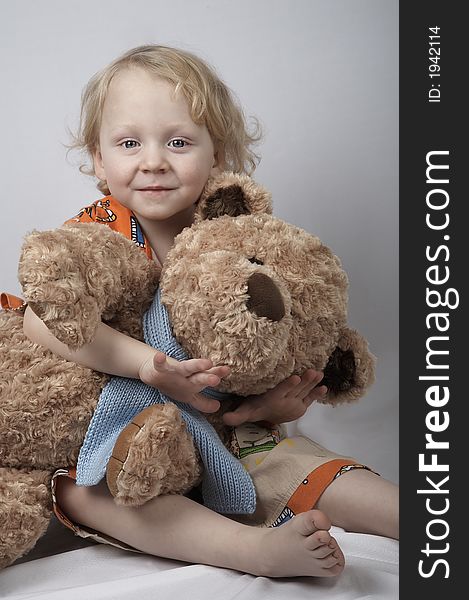 Smiling boy with teddy bear