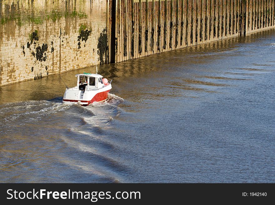 Small fishing boat putting to sea. Small fishing boat putting to sea