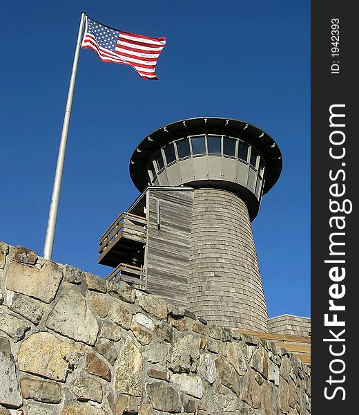 Lookout turret with flag against blue sky