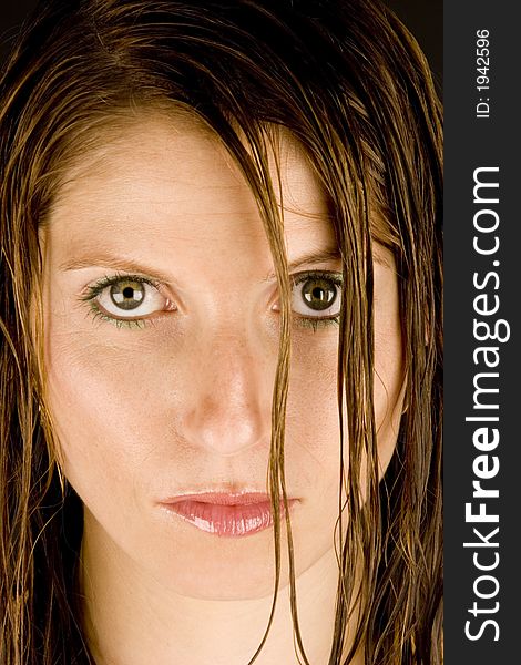 A young woman with wet hair against a plain background.