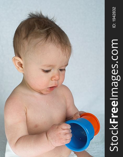 Image of adorable baby playing with stacking cups. Image of adorable baby playing with stacking cups