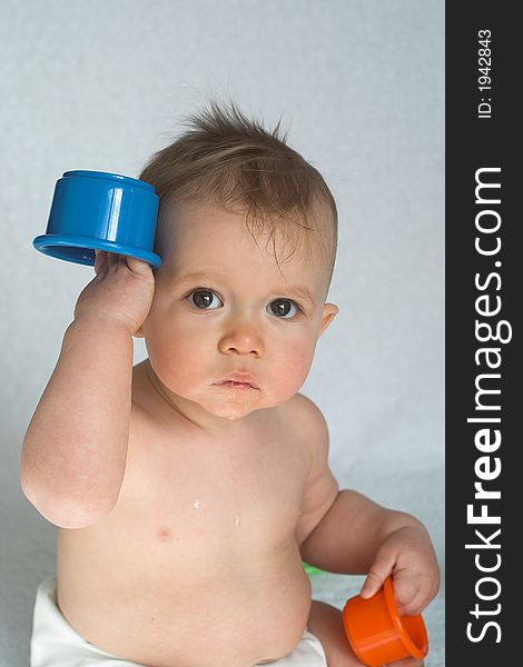 Image of adorable baby playing with stacking cups. Image of adorable baby playing with stacking cups