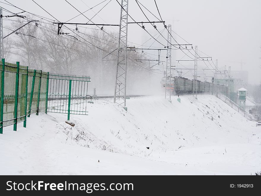 Snow falls. Railway tracks and train. Snow falls. Railway tracks and train.