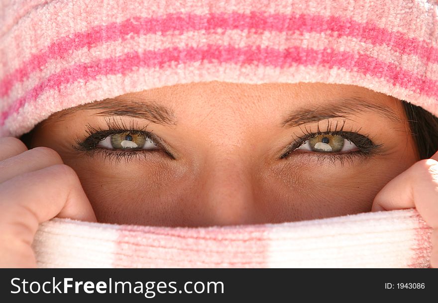 Young woman with beautiful eyes covering nose and mouth