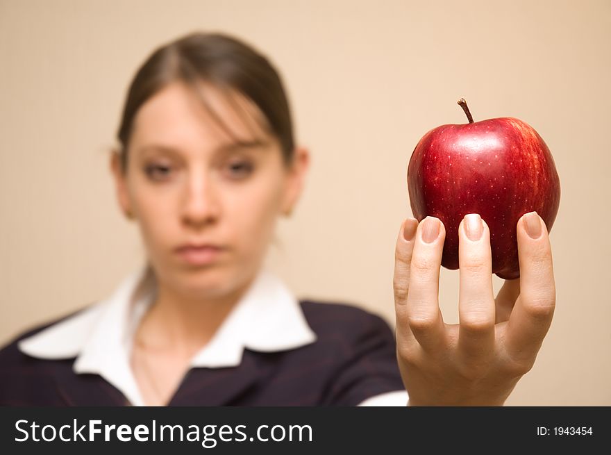 Beautiful woman offering a very tempting apple. Beautiful woman offering a very tempting apple